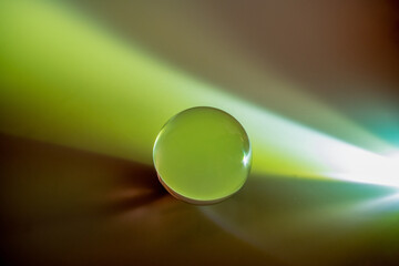 Green reflected in a glass ball on a multicolored background
