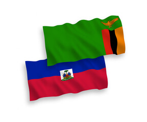 National vector fabric wave flags of Republic of Zambia and Republic of Haiti isolated on white background. 1 to 2 proportion.