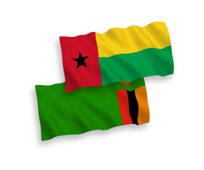National vector fabric wave flags of Republic of Zambia and Republic of Guinea Bissau isolated on white background. 1 to 2 proportion.