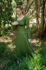 Full length portrait of blondewoman wearing a  beautiful  green medieval fantasy gown. Posing with...