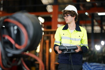 Fototapeta premium Engineer check and control welding robotics automatic arms machine in intelligent factory automotive industrial with monitoring system software. Digital manufacturing operation. Industry 4.0