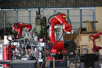 Robotics arm in the metal factory plant . it's performing routine servicing of the welding robotics units equipment.