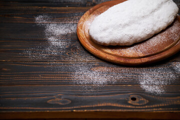 Traditional Christmas stollen cake with marzipan and dried fruit isolated on wooden background