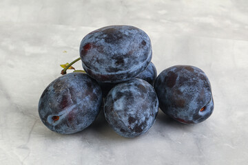Ripe plum heap over background