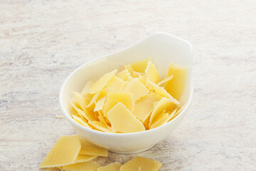 Sliced parmesan cheese heap in the bowl