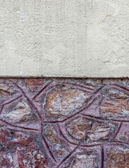 half plaster covered rough stone wall, space for your text