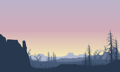 Scenic view of mountains and cliffs with silhouettes of dry pine trees from the countryside at dusk
