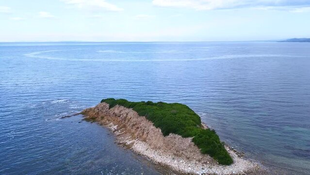 Small exotic lonely island in the blue sea. Summer scene. Aerial view