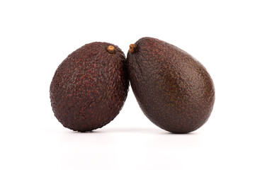 Close-up of two haas avocados on a white background.