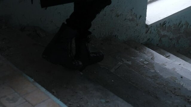 male legs going down the stairs of  old house. slow motion video