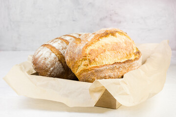 Fresh bread on baking paper.  Image with selective focus.