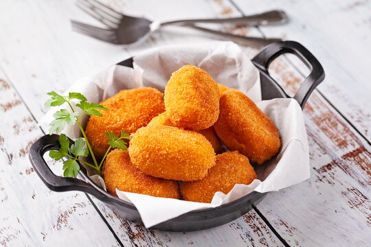 Tapa of croquettes on white table