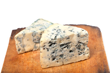 Dorblu cheeses on old wooden kitchen board