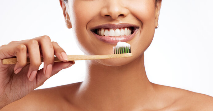 A great smile needs good care. Studio shot of an unrecognisable woman brushing her teeth against a white background.