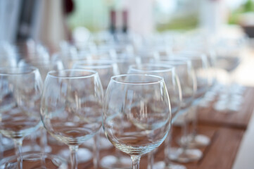 A lot of empty wine glasses stand on the table