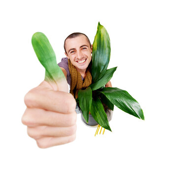 Green fingers. A smiling young gardener holding up his green thumb.