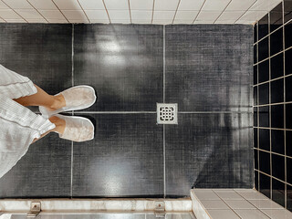 Floor drain, running water in shower, White and black tiles