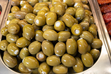 Green fresh olives close up on market, food background