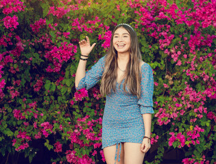 Portrait of a cute latin girl smiling in a garden, cute young brown latin girl smiling in the garden