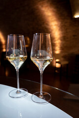 Tasting of brut champagne sparkling wine produced by traditional method in underground caves