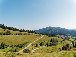 Landscape of Black Forest in Germany. View on  cirque of Nonnenmattweiher, Belchen peak and the serpentine mountain road L131 between the village Haldenhof and Kreuzweg parking area 