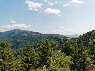 Black Forest landscapes in Southern Germany. View of Forested mountains, pastures in Münstertal valley and bare dome of Belchen peak vom nature reserve of Nonnenmattweiher 