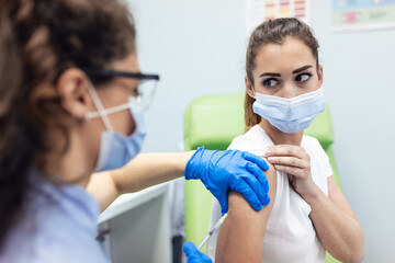 Covid-19 Vaccination. Patient Getting Vaccinated Against Coronavirus. Nurse holding syringe and inject Covid-19 or coronavirus vaccine.Injection covid vaccine concept.