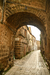 Fototapeta na wymiar A narrow street among the old stone houses of the oldest district of the city of Caserta.