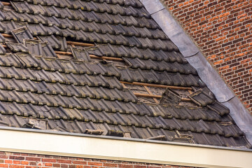 Damage to the roof from storm Eunice. Some roof tiles have been blown off the roof