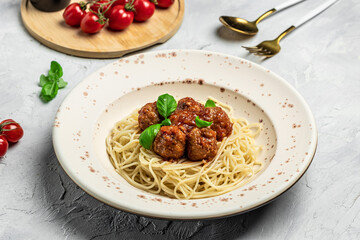 Close-up of Italian pasta with tomato sauce and meatballs. Restaurant menu, dieting, cookbook recipe top view
