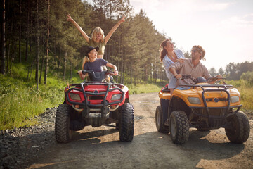 A group of friends enjoy riding quads in the nature. Riding, nature, friendship, together