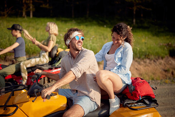Close-up of a group of friends enjoying a quad ride in the nature. Riding, nature, friendship, together © luckybusiness