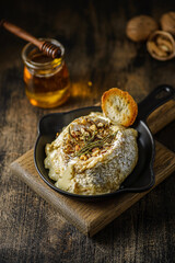 baked brie cheese on a wooden board