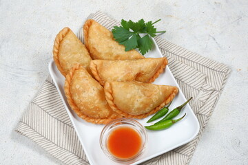 Curry puff or Pastel Goreng is Pastry Popular in Indonesia.
fried pastry with filling of sautéed...