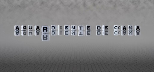 aguardiente de caña word or concept represented by black and white letter cubes on a grey horizon background stretching to infinity - obrazy, fototapety, plakaty