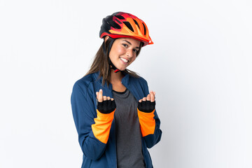 Young cyclist brazilian girl isolated on white  background making money gesture