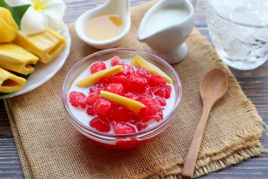 Thai Red Ruby dessert - made from water chestnut coated with flour served in syrup, jackfruits coconut milk and ice in Thai called "Tub Tim Krob" at close up view