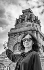 Fototapeta premium Happy woman visiting Monument to the Battle of the Nations in Leipzig.