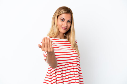 Blonde Uruguayan girl isolated on white background inviting to come with hand. Happy that you came