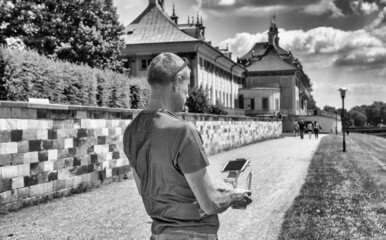 Man outdoor using the remote to control his drone.