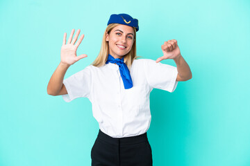 Airplane stewardess Uruguayan woman isolated on blue background counting six with fingers