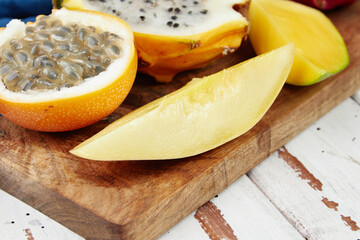 Exotic fruits, tropical fruits mix, healthy food, vegans, wooden table