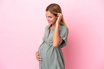 Young Uruguayan woman isolated on blue background pregnant and in lateral position