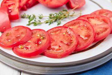 Red, ripe tomatoes on a wood background