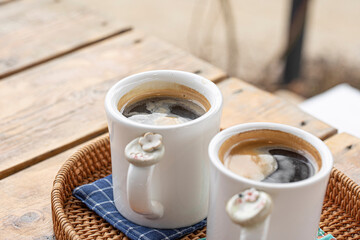Homemade mug cup and coffee on wooden background.