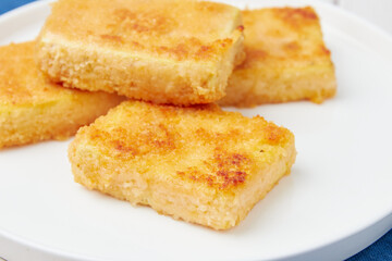 Deep fried tofu nuggets, close-up, wooden table