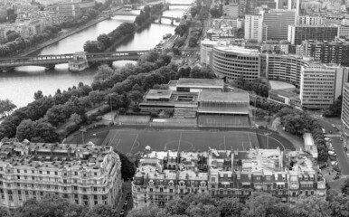 Aerial panoramic view of City skyline, football field and Seine river in Paris, autumn season.