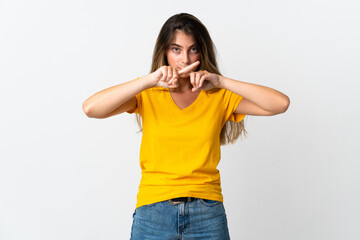 Young caucasian woman isolated on white background showing a sign of silence gesture