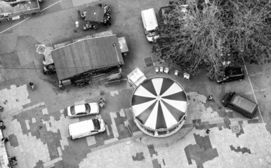 Overhead aerial view of city square and merry-go-round.
