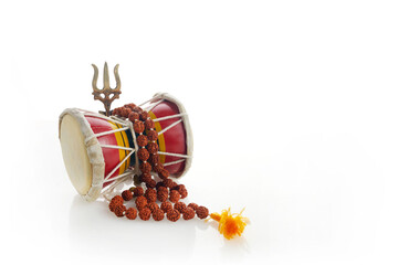 Shivaratri background with Shivas trident and Pellet Drum Damroo musical instrument . Hindu...